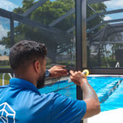 echnician installing new pool cage screen in Sarasota, Florida